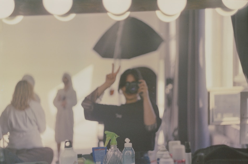 Person taking a selfie in a room with mirrors.
