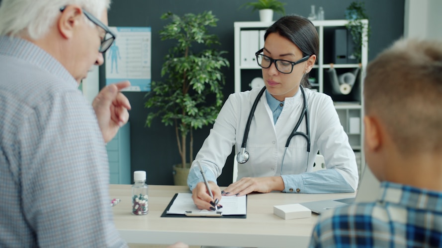 Doctor consults with elderly man and child