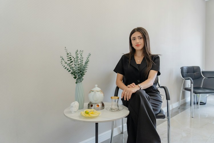 Woman in black sitting in a waiting room